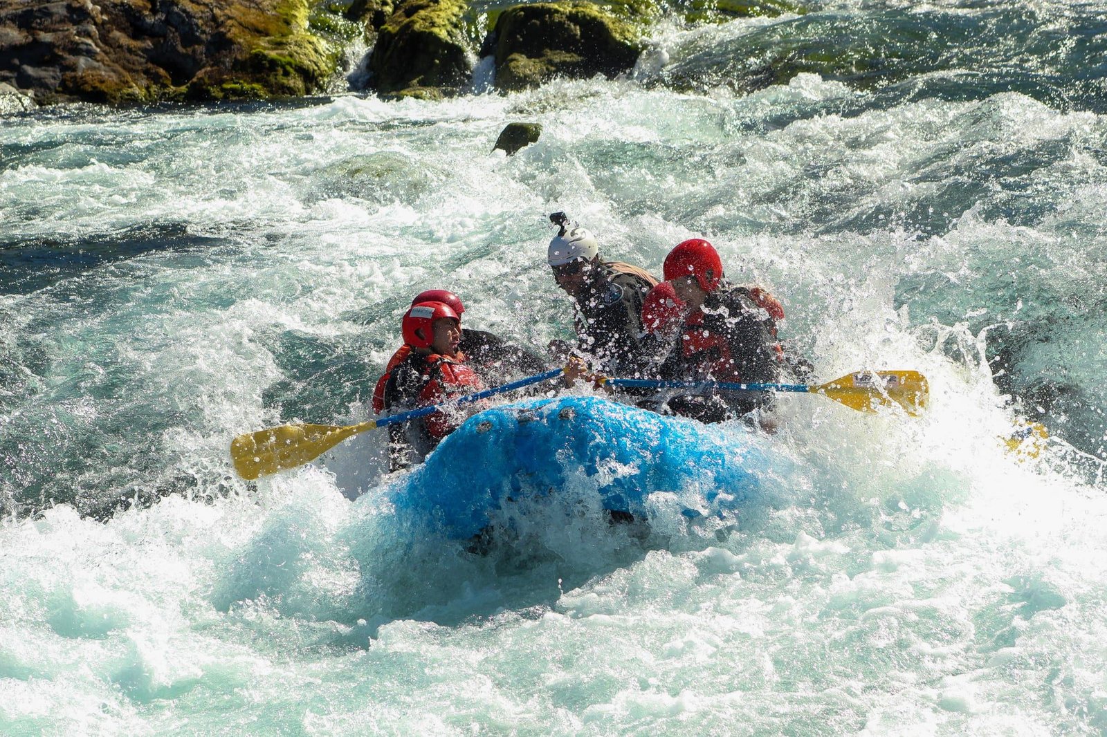 A raft drops through white water waves on the Petrohue River