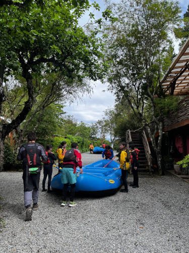 People carrying a raft across the yard at the base
