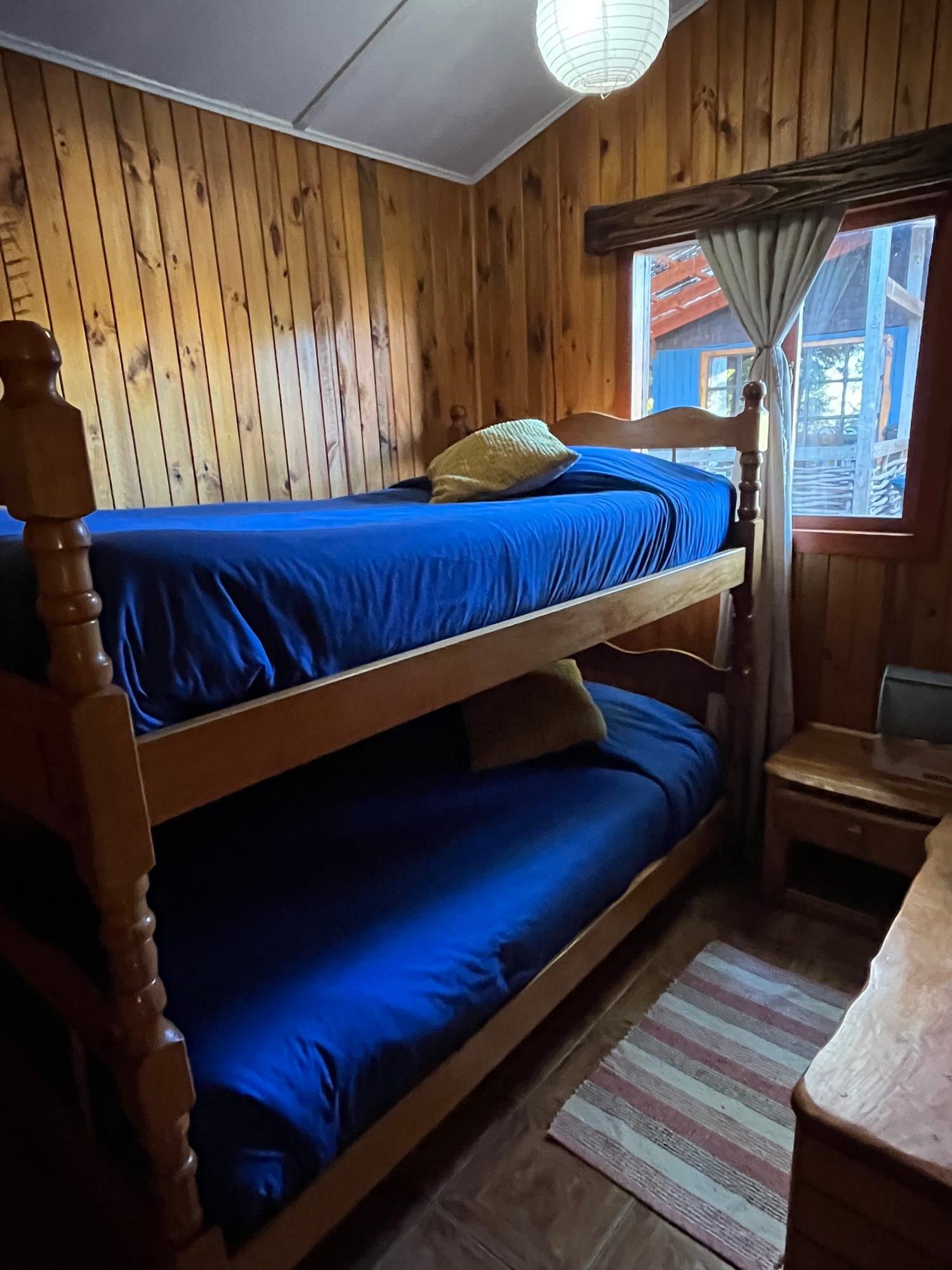 A cabin bedroom with a wooden bunk bed
