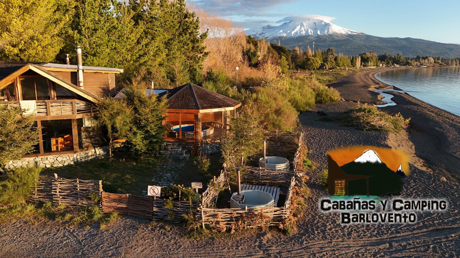 The Barlovento cabins and hot tubs on the Lake Llanquihue beach, with Osorno Volcano behind