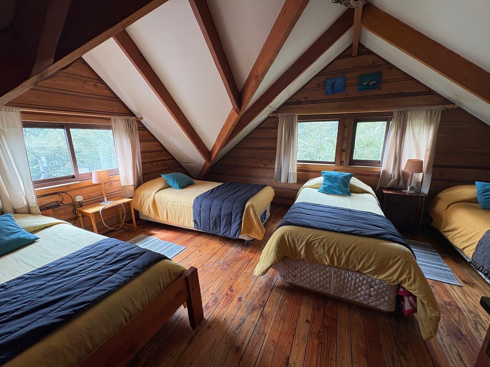 A beach house bedroom with four single beds