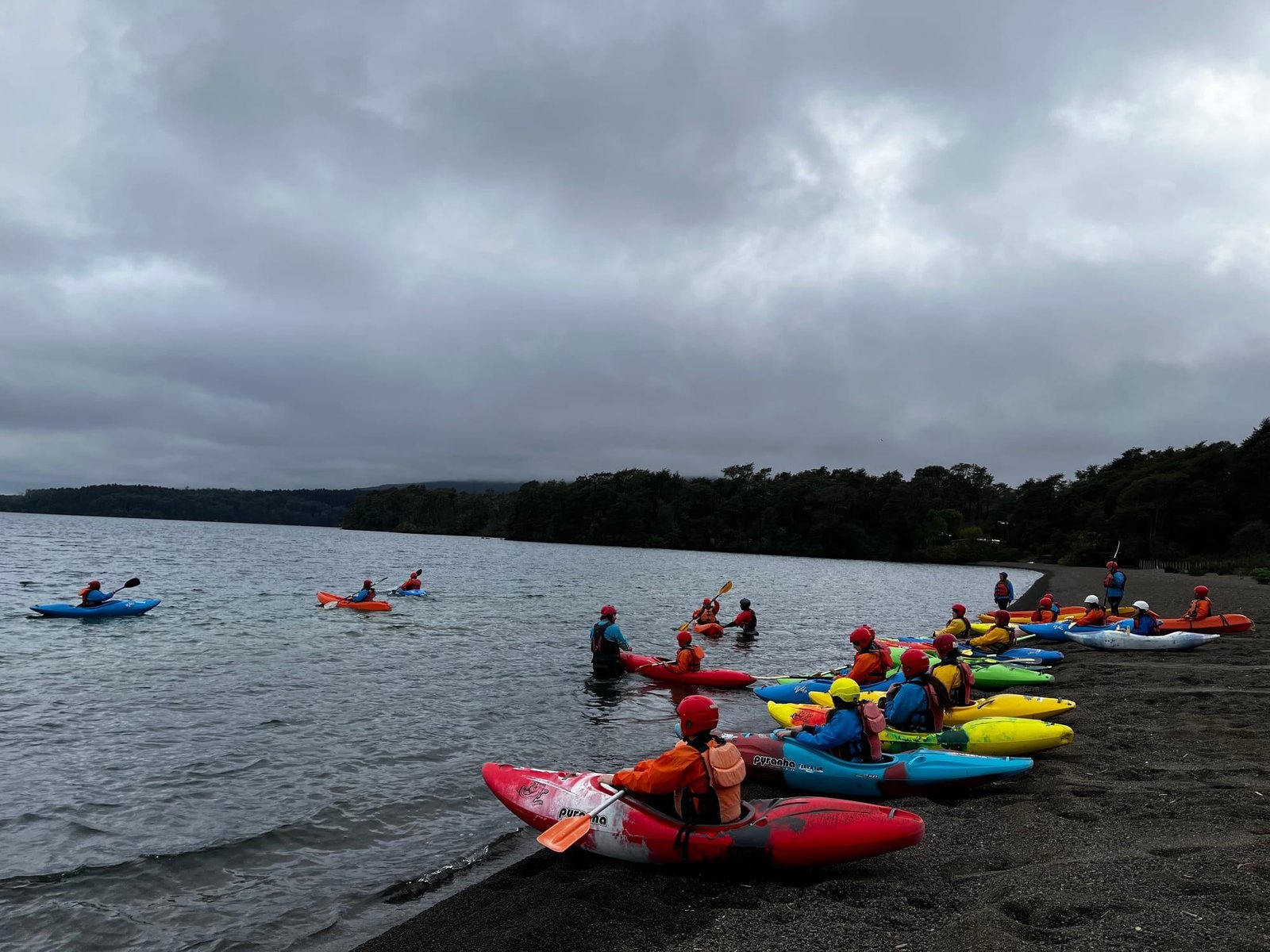 A kayak lesson with colorful kayaks on the shore of Lake Llanquihue