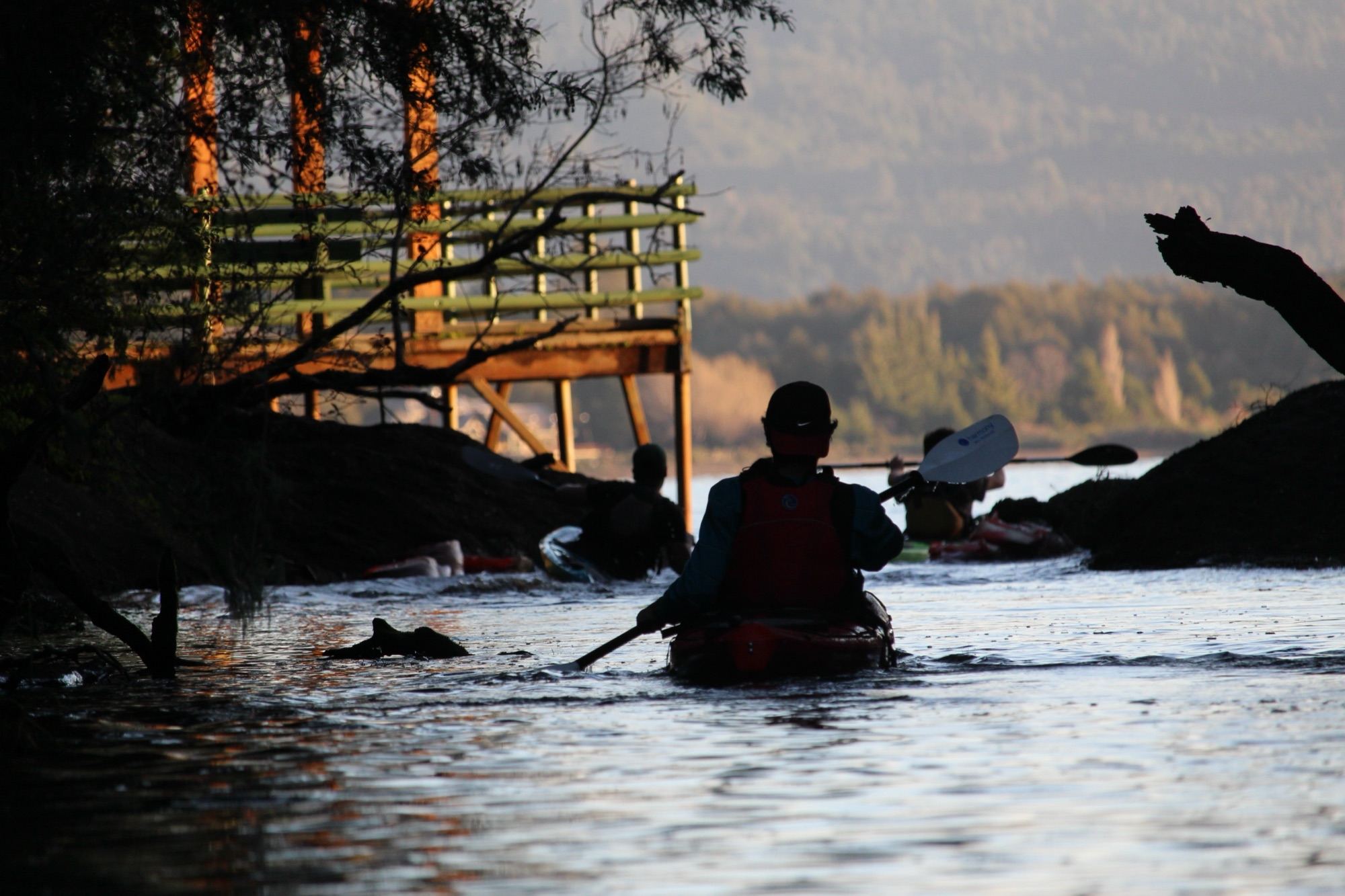 Kayakers at sunset on the shore of Lake Llanquihue, in the Laguna Verde area