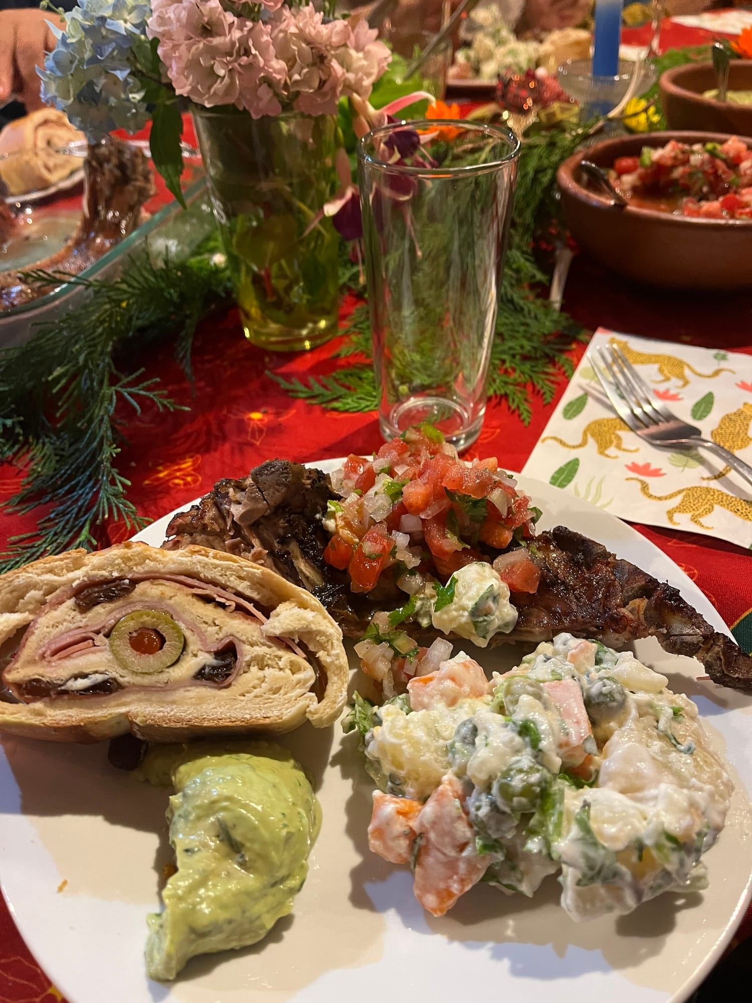 A plate of roasted meat and salads on a decorated table